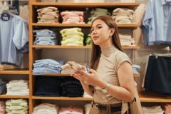 Une jeune femme aux cheveux longs réalise l'estimation d'un local commercial, un carnet à la main