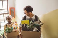 Jeunes avec des cartons dans les mains dans un escalier