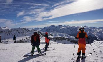 Skieurs qui s'apprêtent à descendre une piste de l'Alpe d'Huez