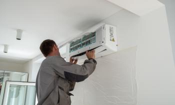 Professionnel qui installe une climatisation